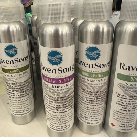 Row of aluminum bottles with labels on a white surface
