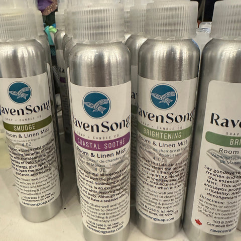 Row of aluminum bottles with labels on a white surface