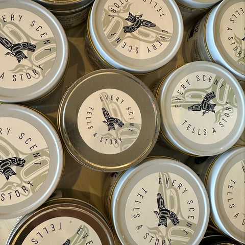 Collection of small containers with 'Every Scent Tells a Story' label.