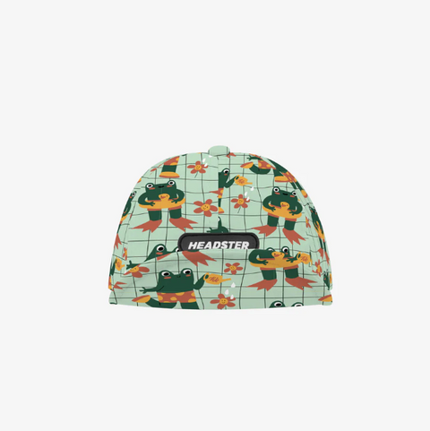 Children's hat with frog pattern and 'HEADSTER' branding on a white background