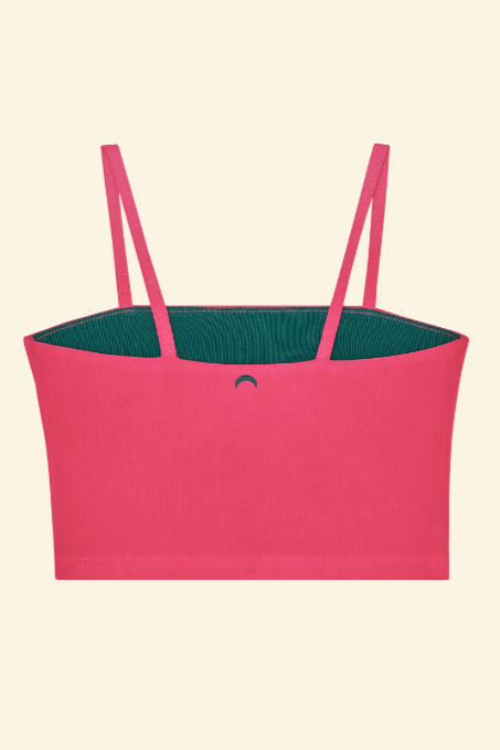 Pink top with green lining on a beige background