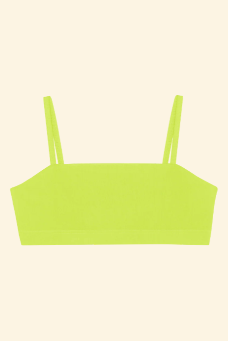 Neon green crop top on a light beige background