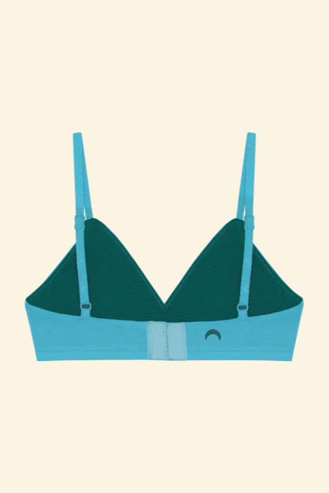 Green and blue bralette on a beige background