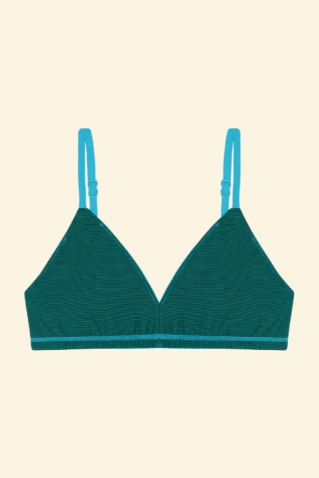 Green bralette on a beige background