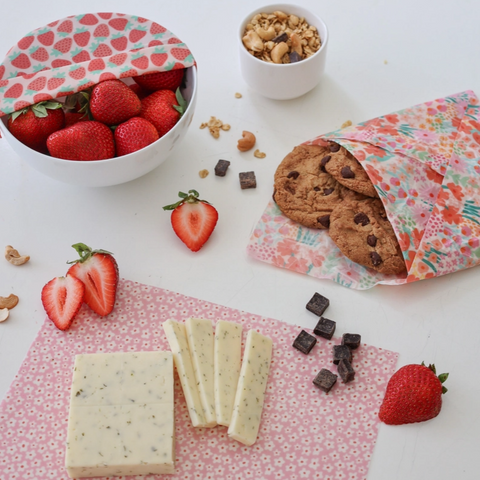 Fragile food packaging with strawberries, cookies, and chocolate on a white surface