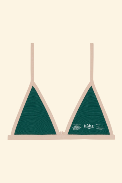 Green bikini top with beige straps on a beige background
