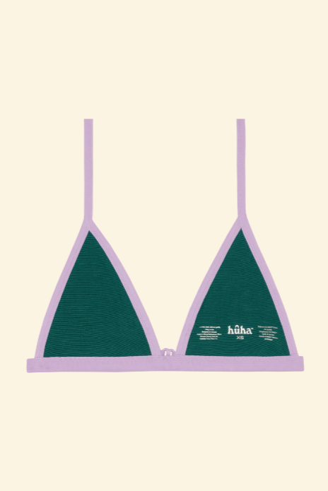 Green bikini top with purple straps on a beige background