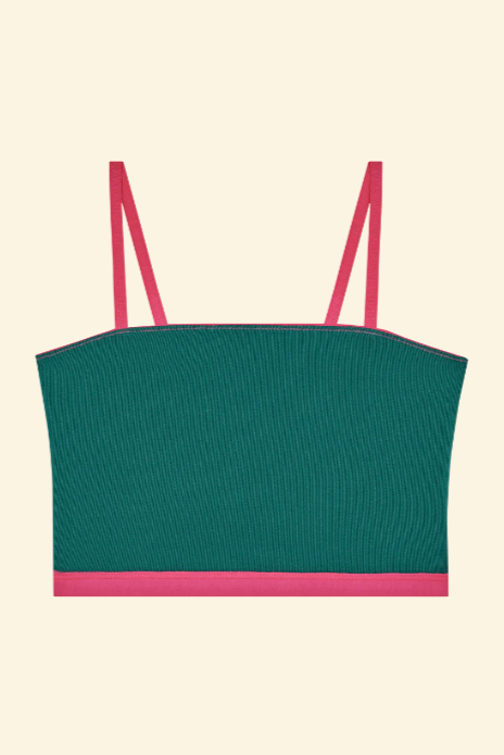 Green crop top with pink straps on a beige background