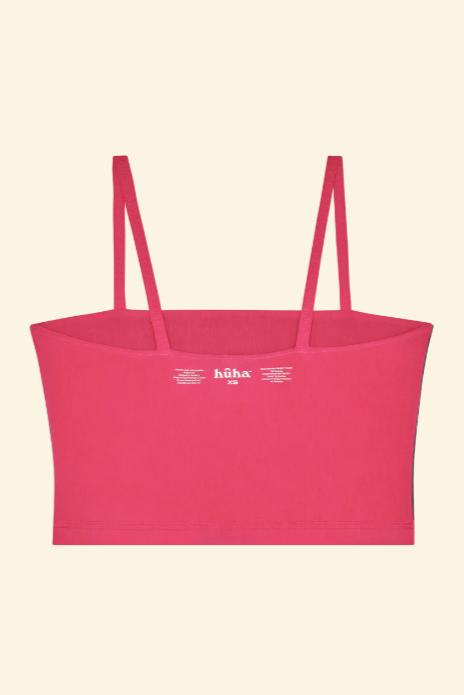 Pink top with thin straps on a beige background