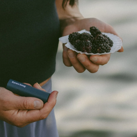 Person holding a shell with truffles and a device labeled 'Napoleon Truffle' outdoors.