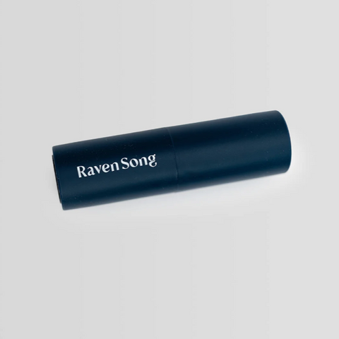 Black cylindrical object with 'Raven Song' text on a light gray background