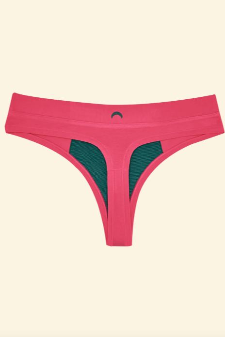 Pink thong with green mesh panels on a beige background