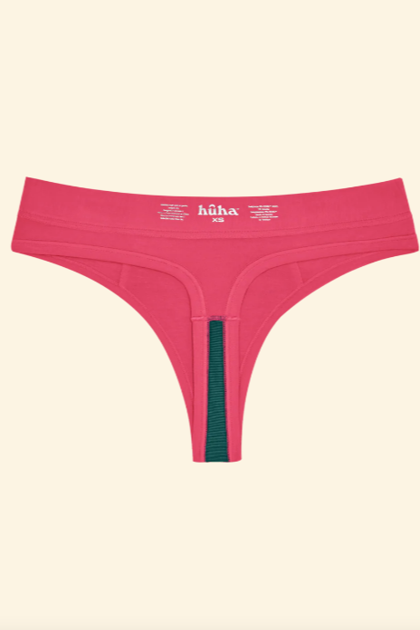 Pink thong with green waistband on a beige background