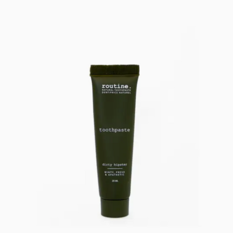 Dark green tube of 'routine' toothpaste on a white background