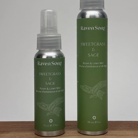 Two green bottles with silver caps labeled 'Raven Soap' on a wooden surface.
