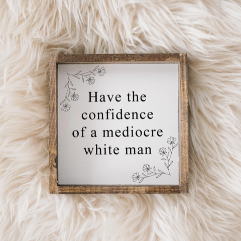 Wooden sign with text on a fluffy white surface