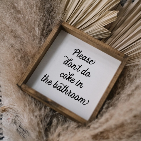 Small wooden sign with text on a textured surface