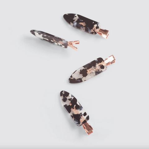 Set of five marbled hair clips with rose gold hardware on a light gray background