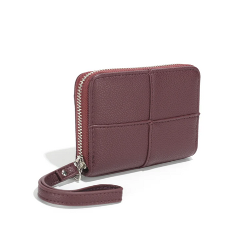 Purple wallet with strap on a white background, featuring vegan leather label.