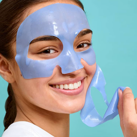 Woman wearing a blue face mask against a light blue background