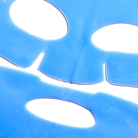 Close-up of a blue plastic sheet with circular cutouts on a white background