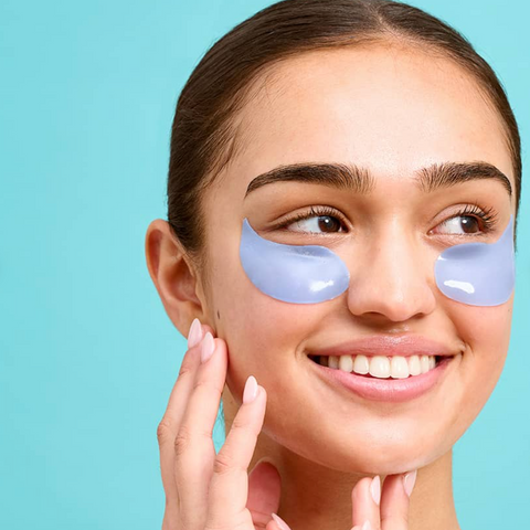Woman wearing eye patches with a blue background