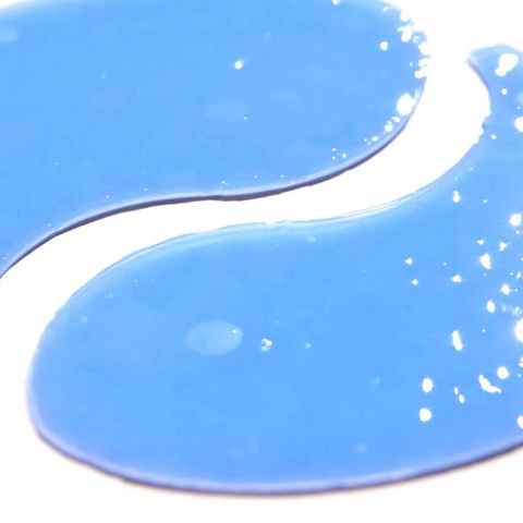 Blue paint swatch with white specks on a white background
