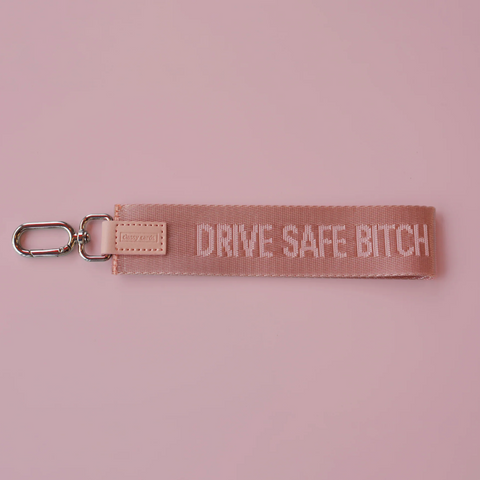 Keychain with 'Drive Safe Bitch' text on a pink background