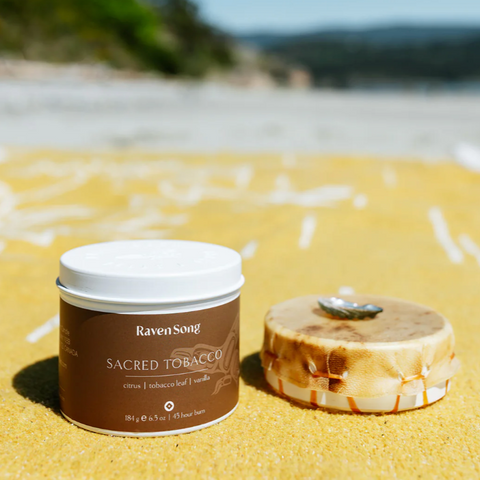 Jar of 'Sacred Tobacco' by RavenSong on a sandy beach with ocean view