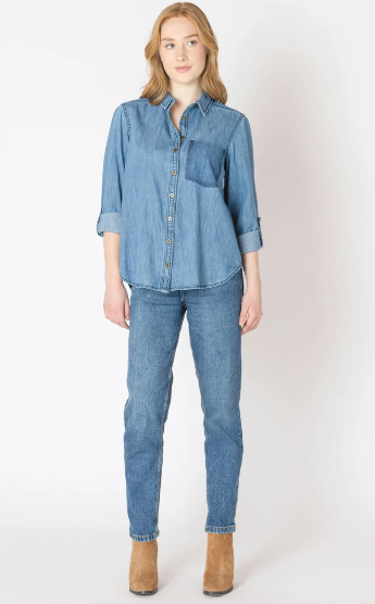 Woman wearing a blue denim shirt and jeans on a white background
