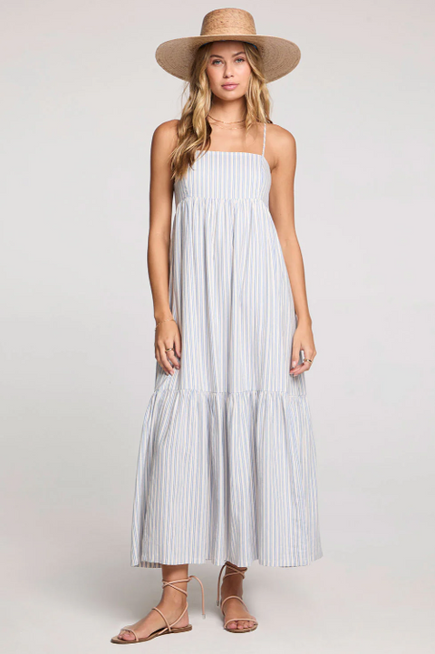 Woman wearing a striped dress and straw hat on a white background