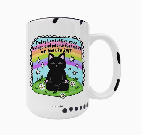 White mug with a black cat illustration and motivational quote on a white background