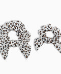 Two leopard print hair scrunchies on a white background