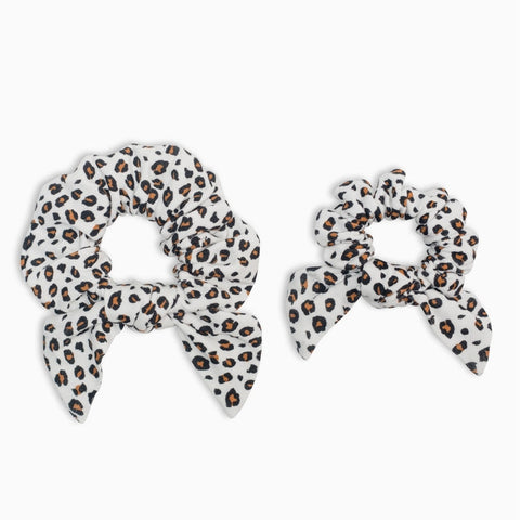 Two leopard print hair scrunchies on a white background