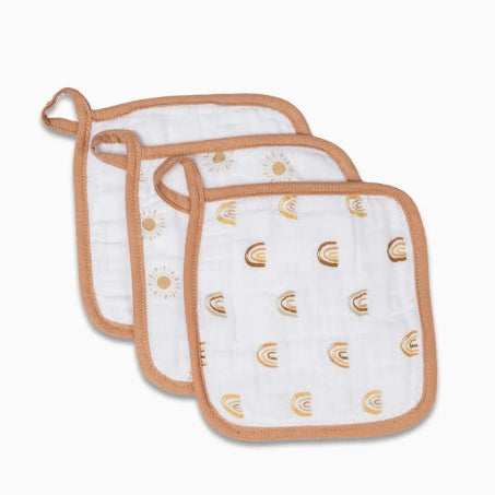 Three white baby bibs with gold patterns on a white background