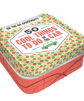 A square metal tin with rounded corners, featuring a retro pattern of green and red polka dots on a pale yellow background on the lid, and orange-red abstract lines on the side. The lid has a white label that reads '50 COOL THINGS TO DO IN THE CAR' with a small green car icon.