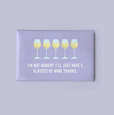 Fridge magnet with wine glass design and humorous text on a purple background