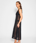 Woman wearing a black lace dress against a white background