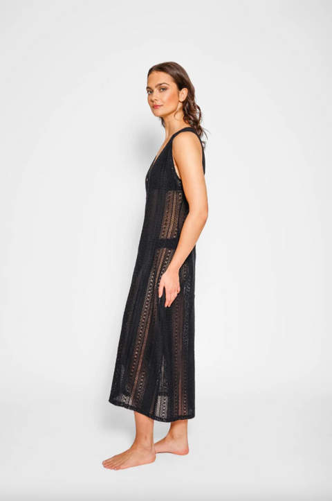 Woman wearing a black lace dress against a white background