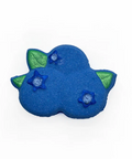 A blueberry-shaped bath bomb with green leaf accents and blue starberry details, shown on a plain white background.