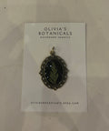Jewelry card with a pendant on a textured surface