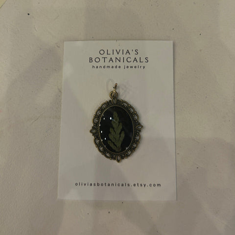 Jewelry card with a pendant on a textured surface
