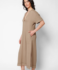 Woman wearing a beige jumpsuit on a white background