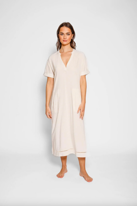 Woman wearing a beige dress on a white background