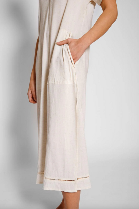 Beige dress with a pocket on a plain background