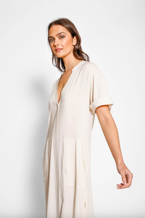 Woman wearing a white dress against a plain background