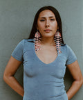 Model wearing matte coral large salmon ghost earrings