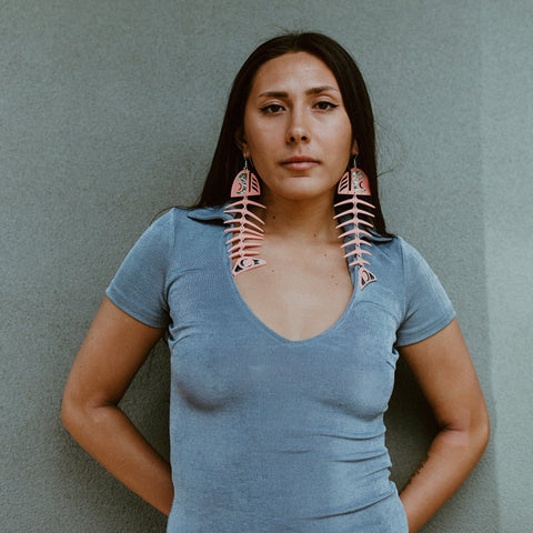 Model wearing matte coral large salmon ghost earrings