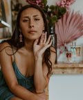 Model wears matte coral small salmon ghost earrings