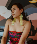 Model wearing Neon Pear Large Salmon Ghost Earrings